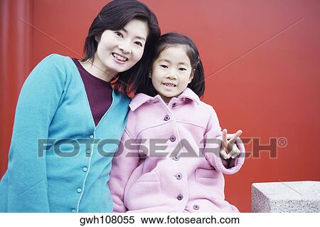 Portrait of a mid adult woman and her daughter View Large Photo Image Stock Photography - Portrait of a mid adult woman and her daughter . Fotosearch