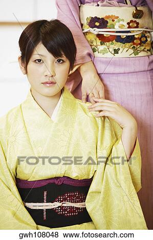 Stock Photo - Portrait of a young woman wearing a Kimono . Fotosearch