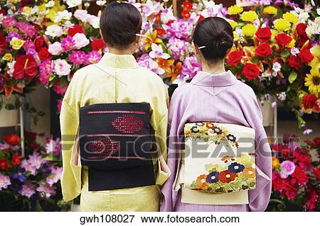 Rear view of a mature woman and her daughter wearing Kimonos View Large Photo Image Stock Photo - Rear view of a mature woman and her daughter wearing Kimonos . Fotosearch