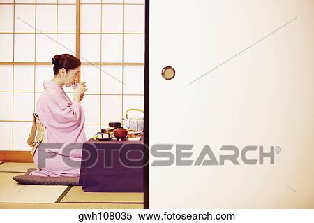 Side profile of a mature woman wearing a Kimono and drinking from a cup View Large Photo Image Stock Photography - Side profile of a mature woman wearing a Kimono and drinking from a cup . Fotosearch