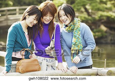Three young women smiling View Large Photo Image Stock Image - Three young women smiling . Fotosearch