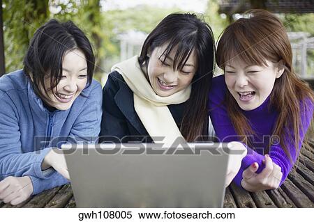 Three young women smiling View Large Photo Image Stock Photography - Three young women smiling . Fotosearch