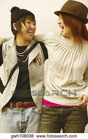Two young women smiling View Large Photo Image Stock Photo - Two young women smiling. Fotosearch