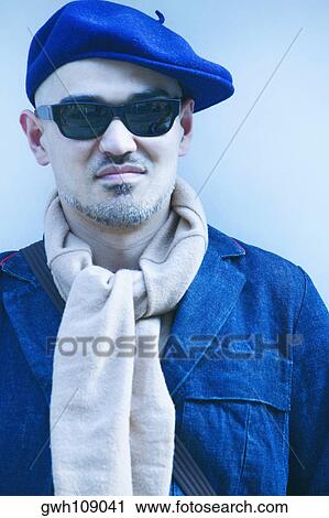 Stock Image - Close-up of a mature man wearing sunglasses. Fotosearch