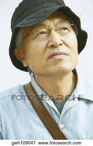 Close-up of a senior man looking up View Large Photo Image Stock Photo - Close-up of a senior man looking up. Fotosearch