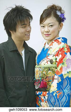 Close-up of a young couple smiling View Large Photo Image Stock Image - Close-up of a young couple smiling. Fotosearch