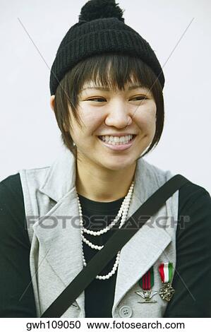 Close-up of a young woman smiling View Large Photo Image Stock Image - Close-up of a young woman smiling. Fotosearch