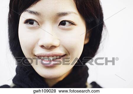 Close-up of a young woman smiling View Large Photo Image Stock Photo - Close-up of a young woman smiling. Fotosearch