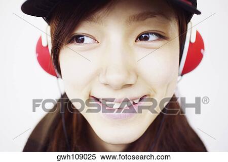 Close-up of a young woman smiling View Large Photo Image Stock Photography - Close-up of a young woman smiling. Fotosearch