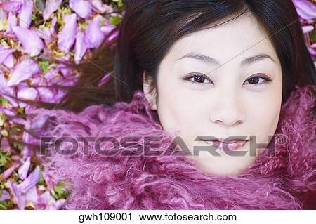 High angle view of a young woman smiling View Large Photo Image Stock Image - High angle view of a young woman smiling. Fotosearch