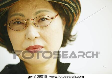 Portrait of a senior woman wearing eyeglasses View Large Photo Image Stock Photo - Portrait of a senior woman wearing eyeglasses. Fotosearch