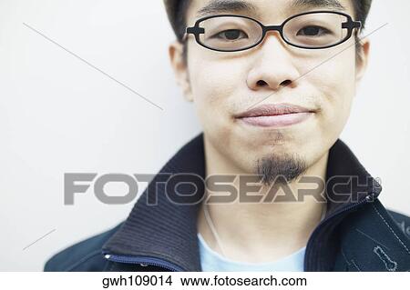 Portrait of a young man smiling View Large Photo Image Picture - Portrait of a young man smiling. Fotosearch