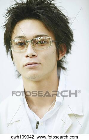 Portrait of a young man wearing sunglasses View Large Photo Image Stock Image - Portrait of a young man wearing sunglasses. Fotosearch