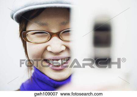 Portrait of a young woman smiling View Large Photo Image Stock Photo - Portrait of a young woman smiling. Fotosearch