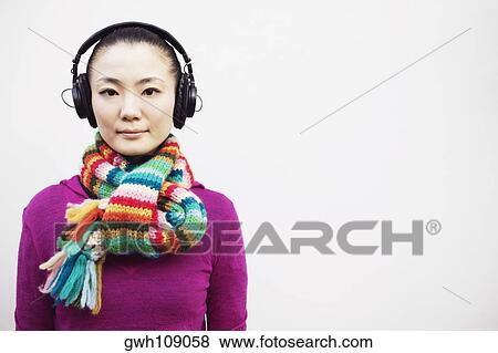 Portrait of a young woman wearing headphones View Large Photo Image Stock Photo - Portrait of a young woman wearing headphones. Fotosearch