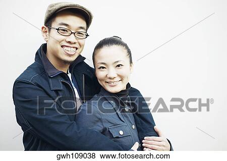 Stock Photo - Side profile of a young man embracing a young woman. Fotosearch