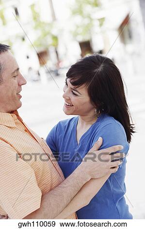 Close-up of a young woman embracing a mature man View Large Photo Image Stock Photo - Close-up of a young woman embracing a mature man . Fotosearch