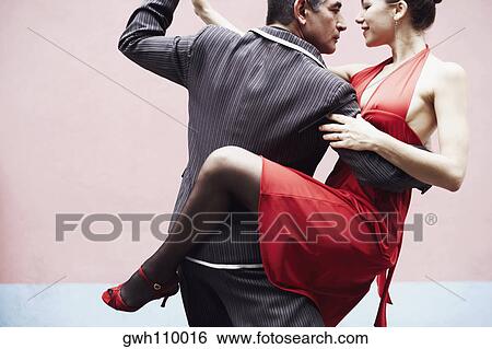 Mature man and a mid adult woman tangoing View Large Photo Image Stock Photograph - Mature man and a mid adult woman tangoing. Fotosearch