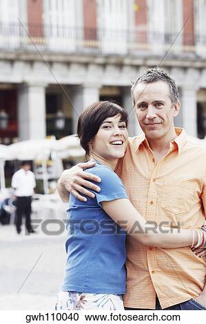Portrait of a mature man and a young woman embracing each other View Large Photo Image Stock Image - Portrait of a mature man and a young woman embracing each other . Fotosearch