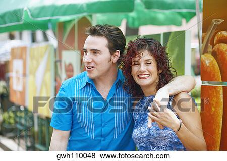 Stock Photo - Portrait of a mature woman and a mid adult man smiling. Fotosearch