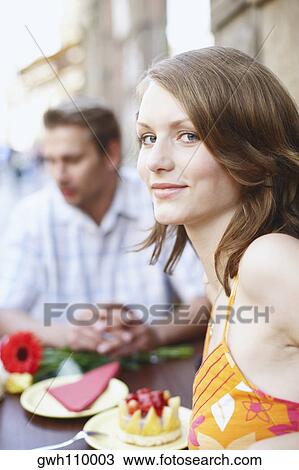 Stock Image - Portrait of a teenage girl seated at a table in a restaurant . Fotosearch