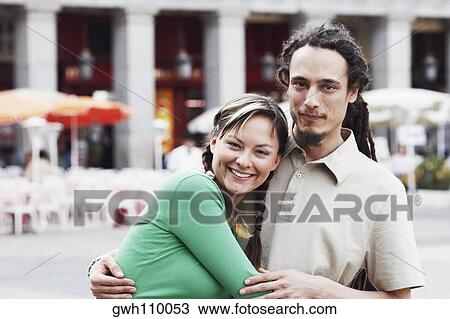 Portrait of a young couple embracing each other and smiling View Large Photo Image Stock Image - Portrait of a young couple embracing each other and smiling . Fotosearch