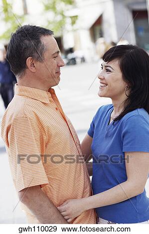 Side profile of a mature man and a young woman standing face to face View Large Photo Image Stock Photo - Side profile of a mature man and a young woman standing face to face . Fotosearch