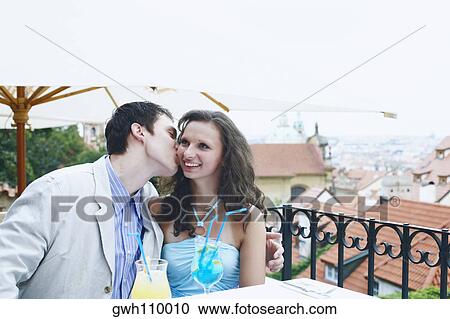 Young man kissing a young woman View Large Photo Image Stock Image - Young man kissing a young woman . Fotosearch