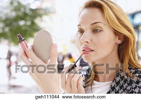 Close-up of a young woman applying lip liner View Large Photo Image Picture - Close-up of a young woman applying lip liner. Fotosearch