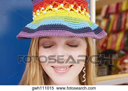 Stock Photography - Close-up of a young woman wearing a knitted hat. Fotosearch