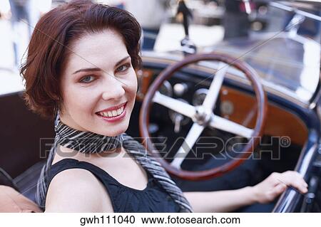 High angle view of a young woman in a car View Large Photo Image Stock Image - High angle view of a young woman in a car . Fotosearch