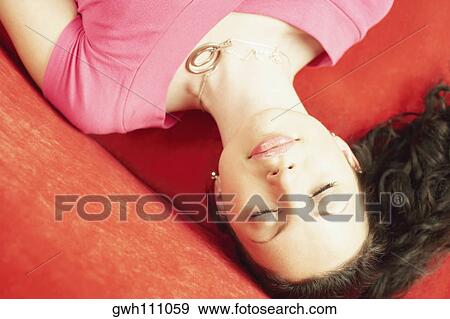 High angle view of a young woman sleeping View Large Photo Image Stock Photo - High angle view of a young woman sleeping. Fotosearch