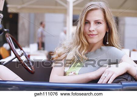 Portrait of a young woman in a car View Large Photo Image Stock Photograph - Portrait of a young woman in a car . Fotosearch