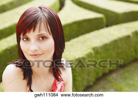 Portrait of a young woman in a garden View Large Photo Image Picture - Portrait of a young woman in a garden . Fotosearch