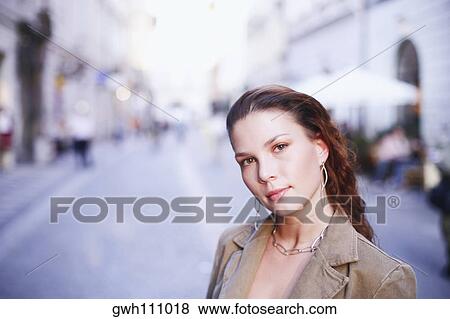 Stock Photo - Portrait of a young woman on the street . Fotosearch