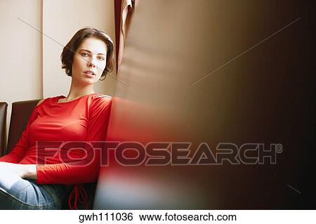 Portrait of a young woman sitting View Large Photo Image Stock Photograph - Portrait of a young woman sitting. Fotosearch