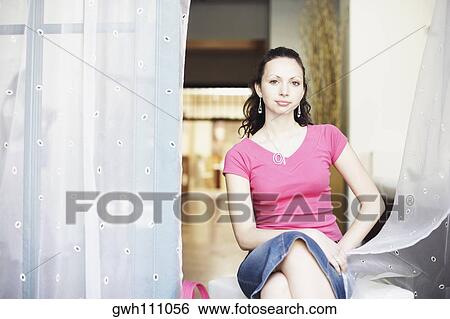 Portrait of a young woman sitting View Large Photo Image Stock Photograph - Portrait of a young woman sitting . Fotosearch