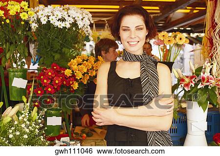 Portrait of a young woman standing in a flower market View Large Photo Image Stock Photograph - Portrait of a young woman standing in a flower market . Fotosearch