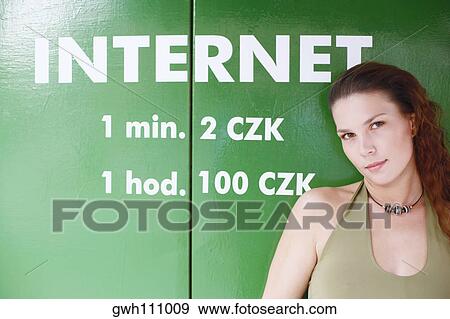 Portrait of a young woman standing in front of a sign View Large Photo Image Stock Photo - Portrait of a young woman standing in front of a sign . Fotosearch