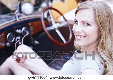 Side profile of a young woman in a car View Large Photo Image Picture - Side profile of a young woman in a car . Fotosearch