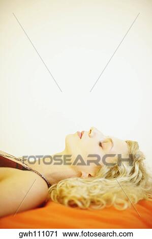 Side profile of a young woman sleeping on the bed View Large Photo Image Stock Image - Side profile of a young woman sleeping on the bed. Fotosearch