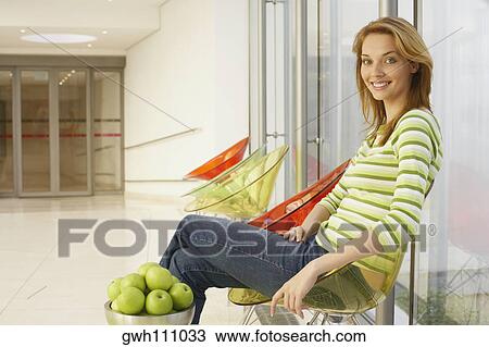 Side profile of a young woman smiling View Large Photo Image Stock Image - Side profile of a young woman smiling. Fotosearch