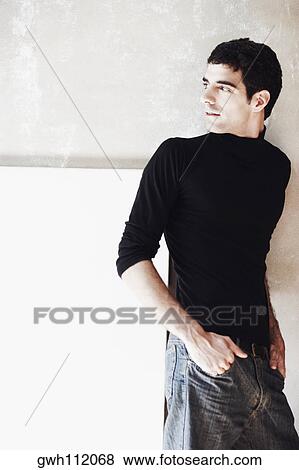 Stock Photo - Close-up of a young man looking over his shoulder. Fotosearch