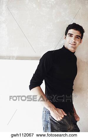 Close-up of a young man with his hands in his pocket View Large Photo Image Stock Photo - Close-up of a young man with his hands in his pocket. Fotosearch