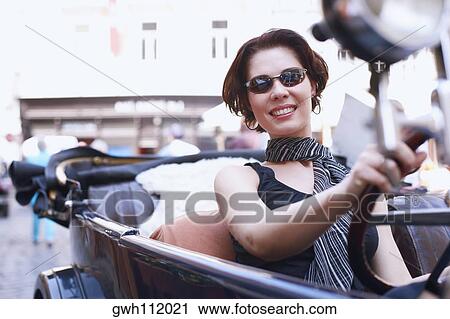Close-up of a young woman driving a car View Large Photo Image Stock Image - Close-up of a young woman driving a car . Fotosearch
