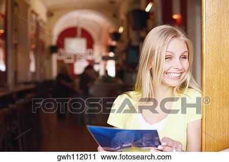 Close-up of a young woman holding a menu card  View Large Photo Image Stock Image - Close-up of a young woman holding a menu card . Fotosearch