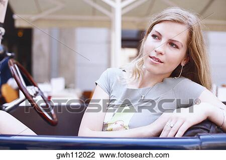 Stock Image - Close-up of a young woman in a car . Fotosearch