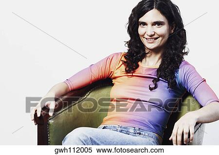 Portrait of a mid adult woman sitting in an armchair View Large Photo Image Stock Photography - Portrait of a mid adult woman sitting in an armchair. Fotosearch
