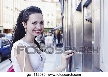 Portrait of a young woman holding a credit card View Large Photo Image Stock Image - Portrait of a young woman holding a credit card . Fotosearch