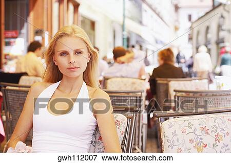 Portrait of a young woman sitting in a restaurant View Large Photo Image Stock Photo - Portrait of a young woman sitting in a restaurant . Fotosearch